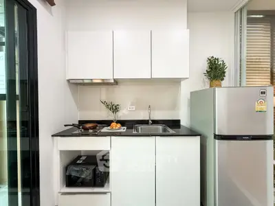 Modern compact kitchen with sleek cabinets and stainless steel appliances