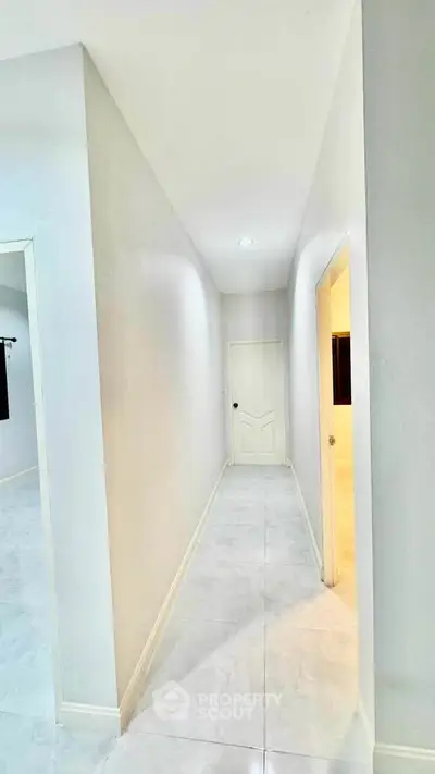 Bright hallway with white walls and doors in modern home interior