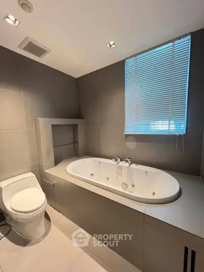 Modern bathroom with sleek design featuring a luxurious bathtub and elegant fixtures.