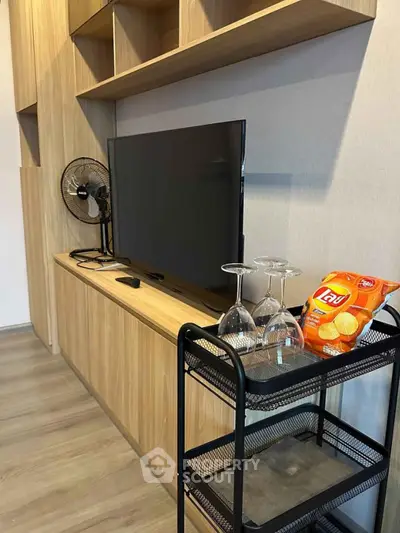 Modern living room with sleek TV setup and stylish shelving