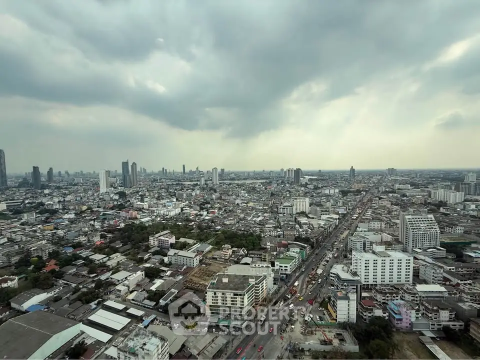 Stunning cityscape view showcasing expansive urban skyline under dramatic cloudy skies.