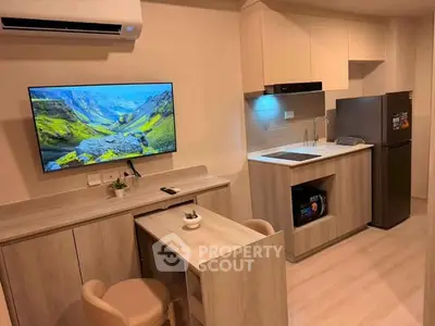 Modern compact kitchen with integrated appliances and stylish cabinetry in cozy apartment.