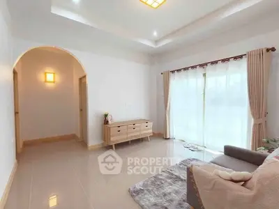 Spacious living room with modern decor and large windows for natural light.