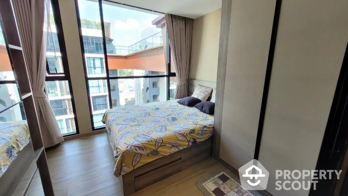 Modern bedroom with large windows and stylish decor in a contemporary apartment