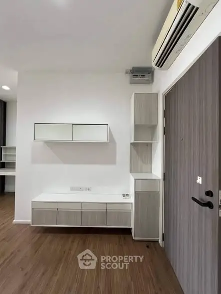 Modern minimalist interior with sleek storage and air conditioning unit.