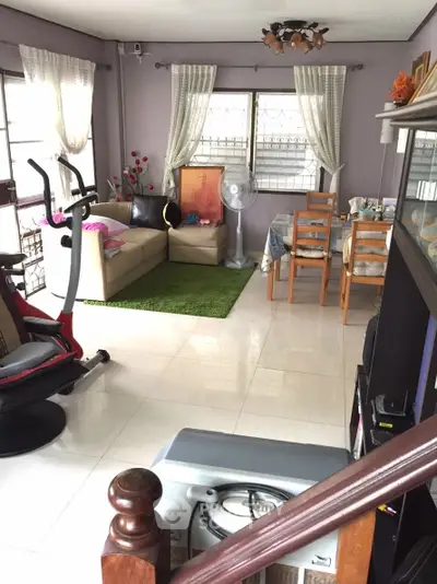 Spacious living room with modern decor and exercise equipment, perfect for relaxation and fitness.