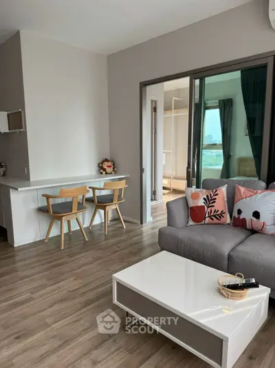 Modern living room with stylish decor and open layout, featuring a cozy seating area and dining space.