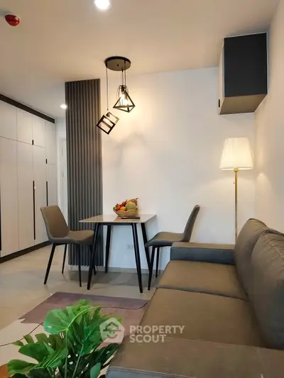 Modern living room with stylish furniture and elegant lighting in a cozy apartment.