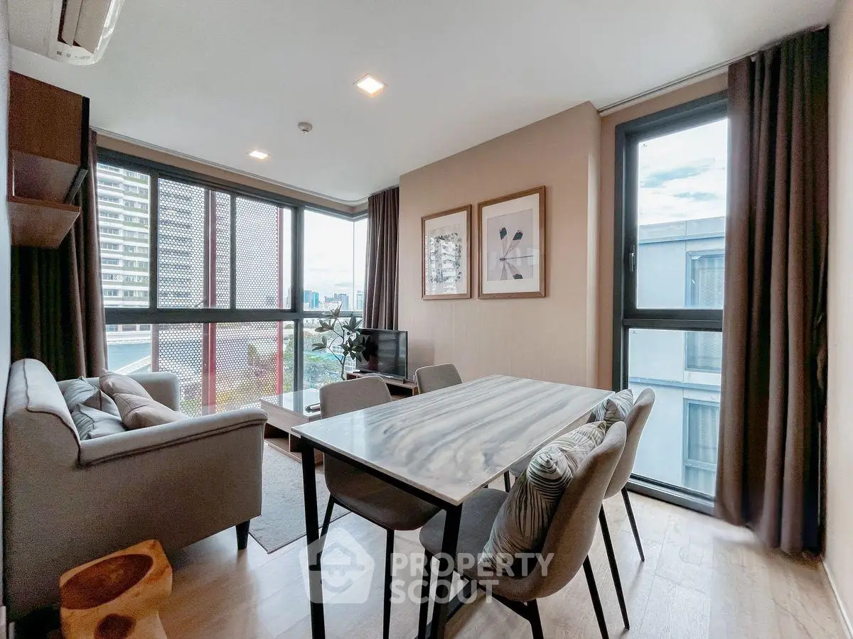 Modern living room with large windows and stylish decor in urban apartment