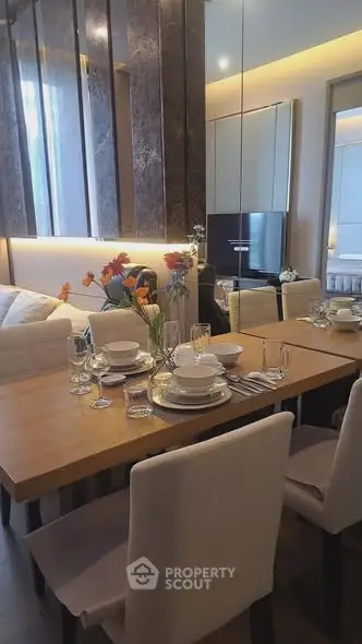 Elegant dining area with modern decor and ambient lighting in a stylish apartment.