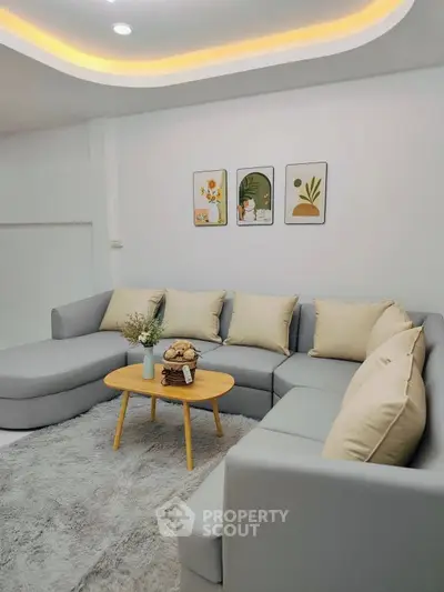 Modern living room with stylish gray sectional sofa and cozy decor
