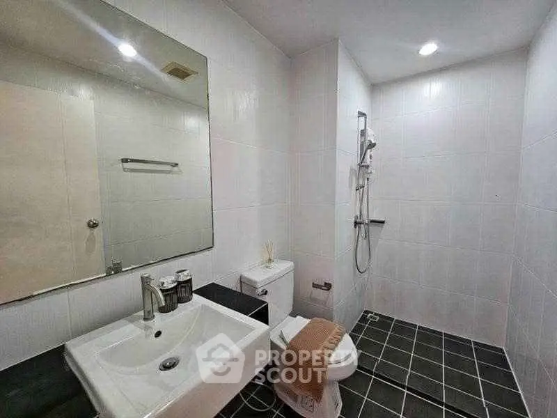 Modern bathroom with sleek fixtures and spacious shower area.