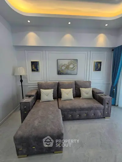 Luxurious living room with plush gray sectional sofa and elegant decor, perfect for modern comfort and style.