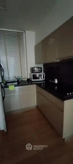 Modern kitchen with sleek cabinetry and appliances in a cozy layout.