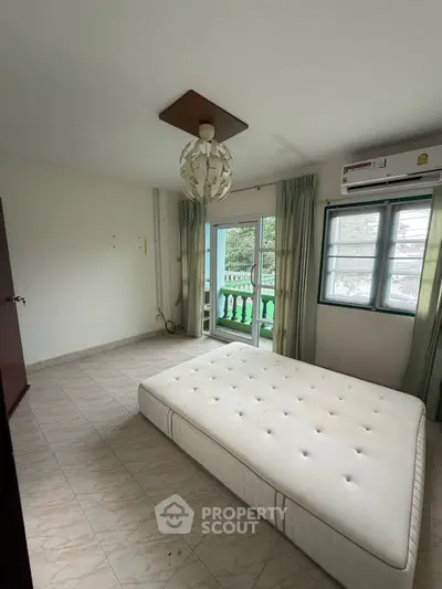 Spacious bedroom with balcony access and natural light