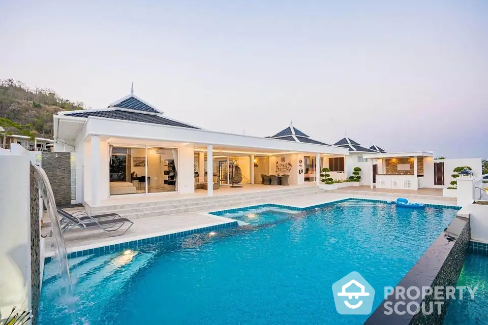 Luxurious modern villa with spacious pool and elegant architecture, perfect for serene living.