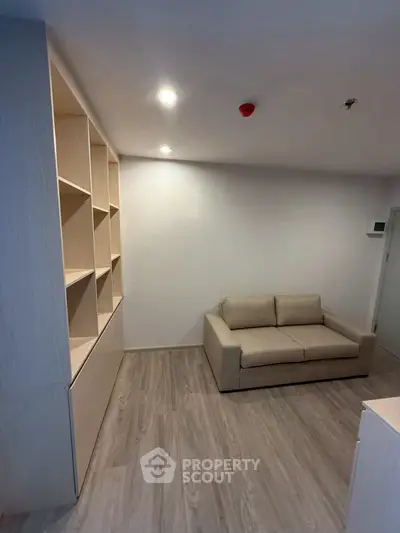 Modern living room with cozy sofa and built-in shelving, perfect for urban living.