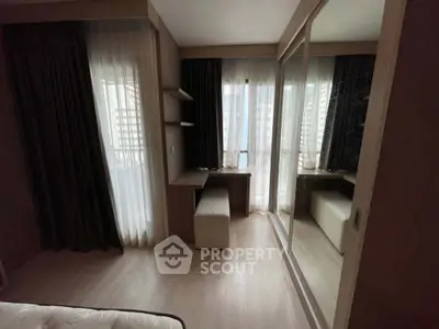 Modern bedroom with large mirrored wardrobe and natural light