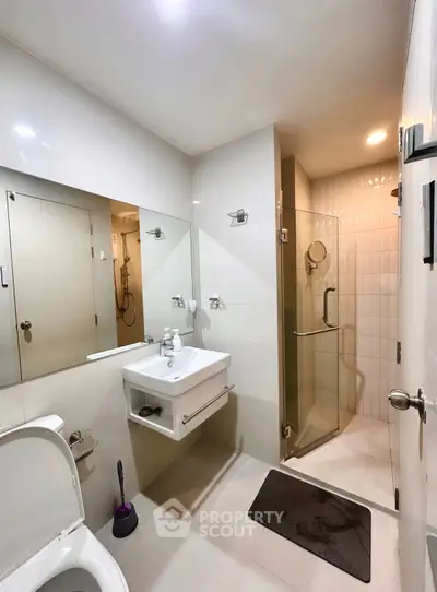 Modern bathroom with sleek fixtures and glass shower enclosure