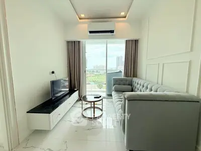 Modern living room with sleek design, featuring a plush sofa, TV, and expansive city view through large windows.