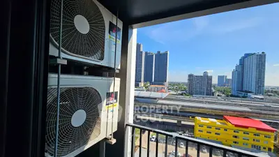 Stunning city view from balcony with modern air conditioning units installed.