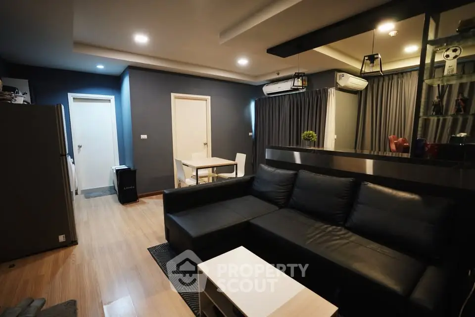 Modern living room with sleek black sofa and stylish decor