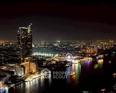 Stunning night view of a vibrant cityscape with illuminated skyscrapers and a lively waterfront.