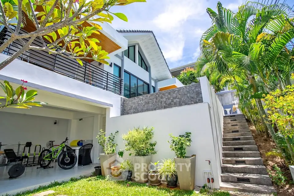 Stunning modern home with lush garden and outdoor staircase, perfect for luxury living.