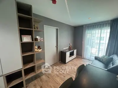 Modern living room with stylish decor and natural light, featuring a cozy seating area and elegant shelving.