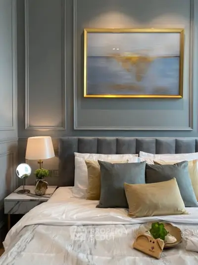 Luxurious bedroom with elegant decor and plush bedding in a modern apartment.