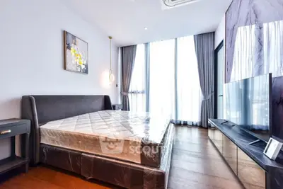 Modern bedroom with large windows and stylish decor in luxury apartment