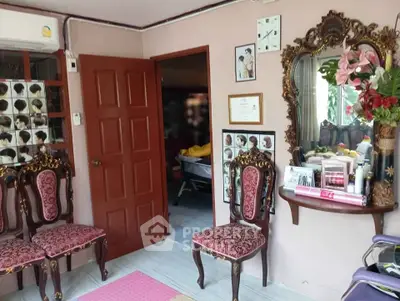 Charming interior with ornate chairs and decorative mirror in cozy room.