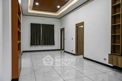 Spacious modern living room with elegant wooden accents and tiled flooring