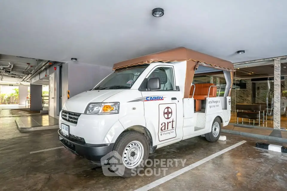 Covered parking area with a parked shuttle van in a modern building