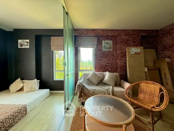 Cozy living room with modern decor and natural light, featuring a comfortable sofa and stylish chairs.