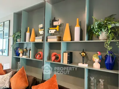 Stylish living room with modern decor and vibrant accents on shelves.