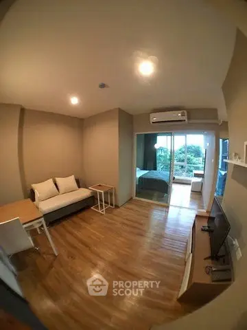 Modern living room with wooden flooring and balcony view