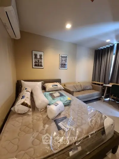 Modern bedroom with cozy sofa and stylish decor in a well-lit apartment