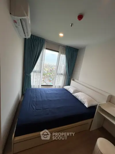 Cozy bedroom with city view, featuring a comfortable bed and modern decor.