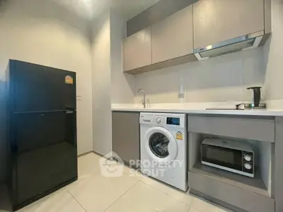 Modern kitchen with sleek appliances and ample storage space.