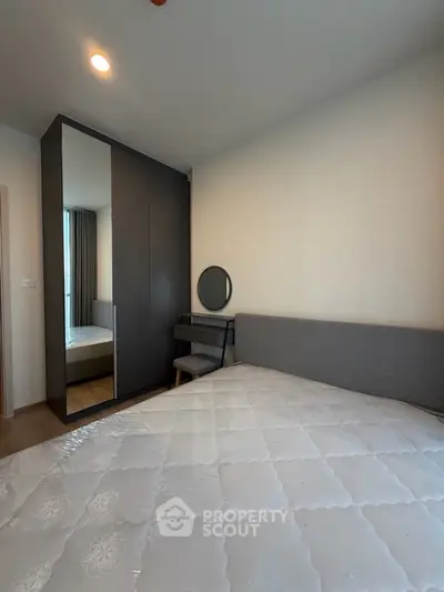 Modern bedroom with sleek wardrobe and cozy bed in a stylish apartment.