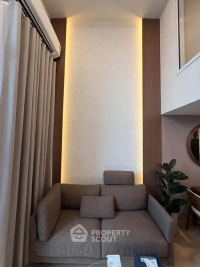 Modern living room with stylish sofa and elegant lighting in a contemporary apartment.