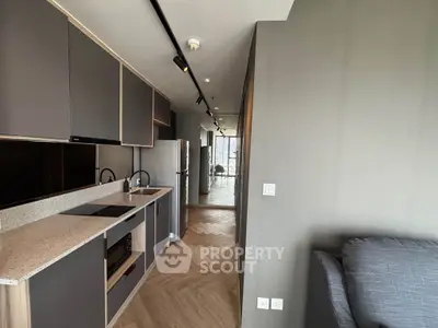 Modern kitchen with sleek cabinetry and open layout in stylish apartment