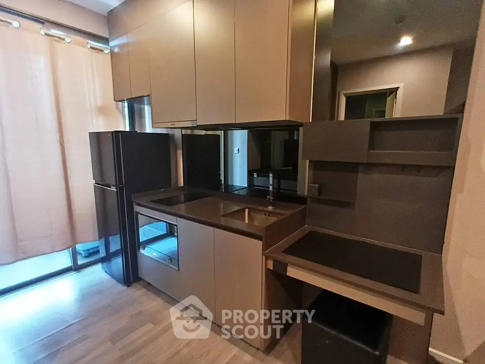 Modern kitchen with sleek cabinetry and built-in appliances in a stylish apartment.