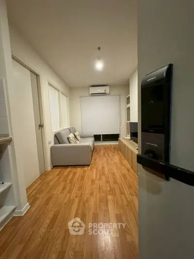 Modern living room with wooden flooring and sleek furniture design