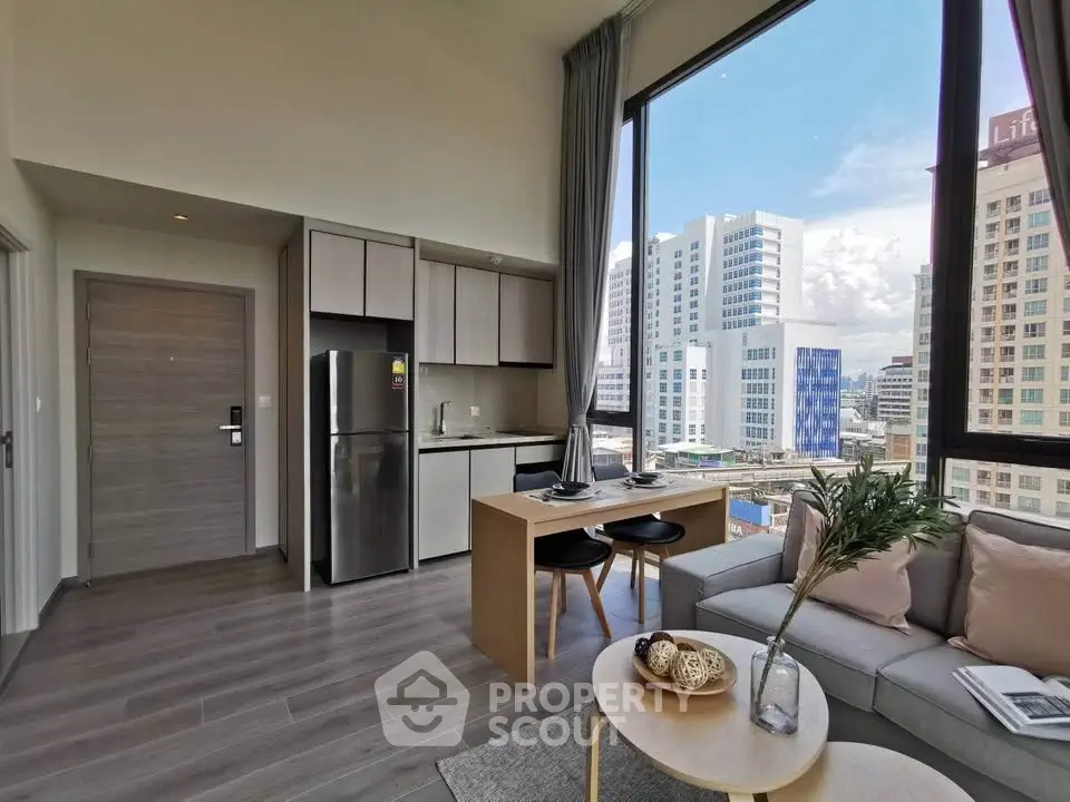 Modern living room with city view, open kitchen, and stylish decor in urban apartment.