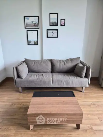 Modern living room with stylish gray sofa and wooden coffee table, perfect for cozy relaxation.