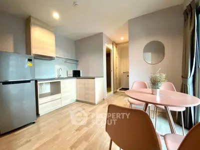 Modern kitchen and dining area with sleek design and natural light