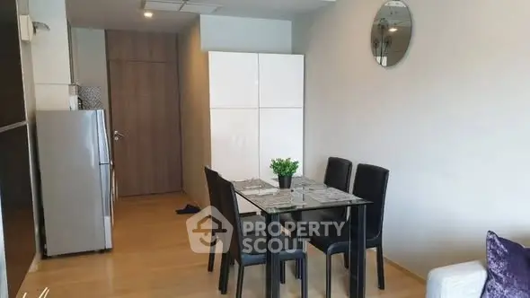 Modern dining area with sleek furniture and stylish decor in a contemporary apartment.