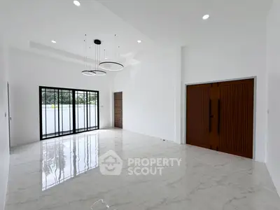 Spacious modern living room with elegant lighting and large windows